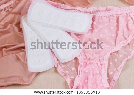 Pink women's underwear and sanitary pads