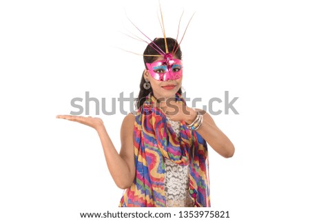 Smiling cheerful girl wearing carnival mask and showing sign isolated on white background