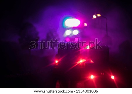 lighting of police car in the night during accident on the road. Artwork table decoration. Selective focus