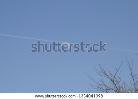 a trace of the jet through moon in the day time