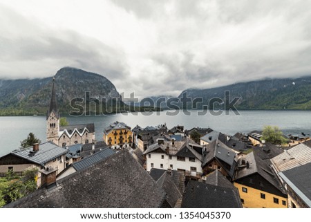 Scenic picture-postcard view of famous Hallstatt mountain village in the Austrian Alps at stormy, cloudy spring, Salzkammergut region, Hallstatt, Austria