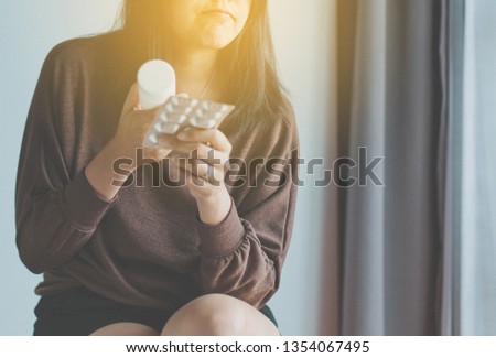 Women using smart phone searching internet and reading drug or pill label and prescription medications,Health care concept,Close up and selective focus