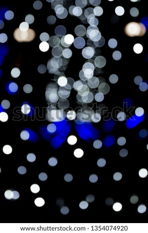 Abstract bokeh of white city lights on black background. defocused and blurred many round light.