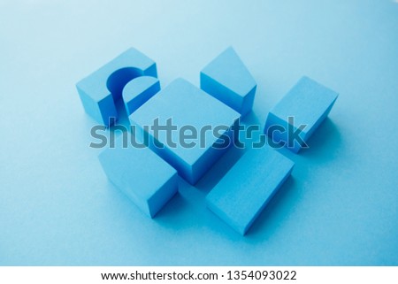 Geometrical figures still life composition. Cube and other objects on blue background. Simplicity concept photography