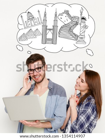 Happy couple choosing tour with laptopand speaking phone at white backround with drawn cloud full of world sights simbols . Travel agency online concept