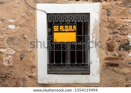 A window with a For Rent sign in the old town of Caceres, Extremadura, Spain.