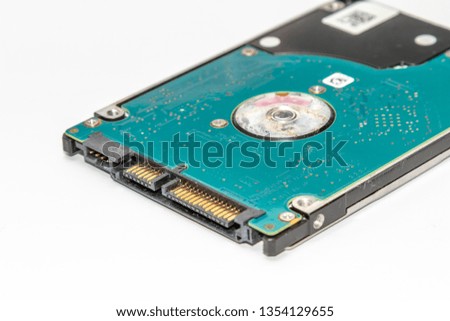 Laptop hard drive with SATA interface with circuit board side flip up reveals blue circuit board isolated on white background