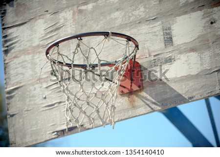 Basketball net on a faded wooden backboard