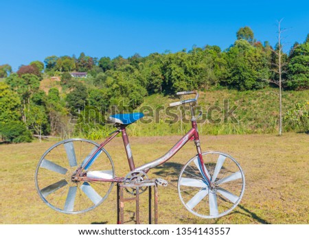 Amazing Bike Wind turbines on Blue Sky Background. Windmills for electric power production on mountain.