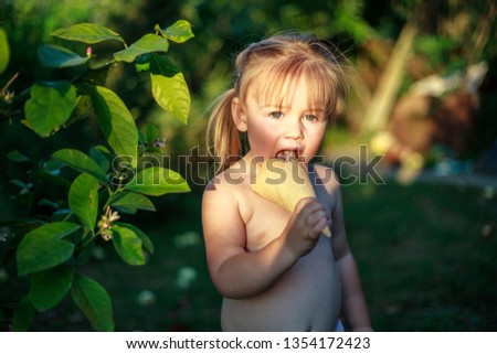 Summer, little girl eating waffle ice cream in the garden