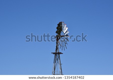 Vintage windmill against a blue sky