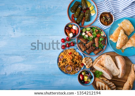 Various Greek dishes on a blue wooden background.Copy space