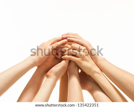 Successful team: many hands holding together on white background Royalty-Free Stock Photo #135422351