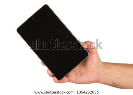 Human hand holds a modern smartphone with a blank chromakey screen in a palm. Technology and advertising concept. Detailed closeup studio shot isolated on abstract blurred white background