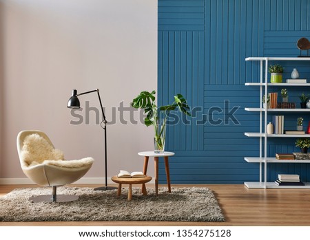 Modern room wall background, white and blue concept, decorative blue room, home object, armchair lamp and frame decor. Bookshelf in the wall, parquet floor.