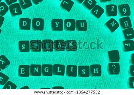 Do you speak English. The question is written in wooden letters: Do you speak English?  Language learning concept. 