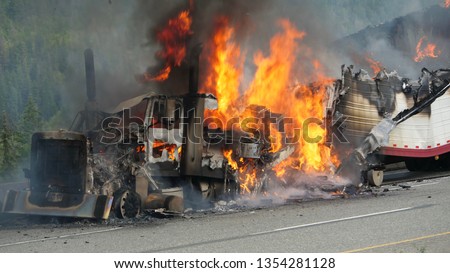 A Semi Truck Burns Out Of Control On The Highway Royalty-Free Stock Photo #1354281128