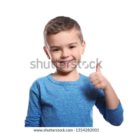 Little boy showing THUMB UP gesture in sign language on white background
