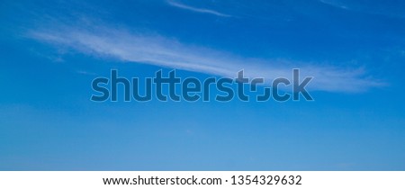 Light blue sky background with a bit of streak of white clouds