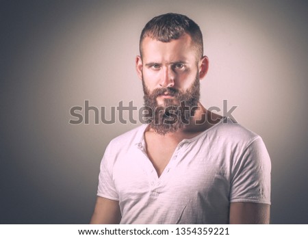 Portrait of handsome man standing, isolated on grey background