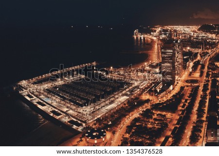 Coast aerial view of Barcelona at night in Spain.