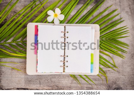 Notepad and stationery on wooden background. Planner for business and study. Fans of stationery