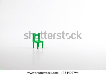 Green toy chair isolated on white background