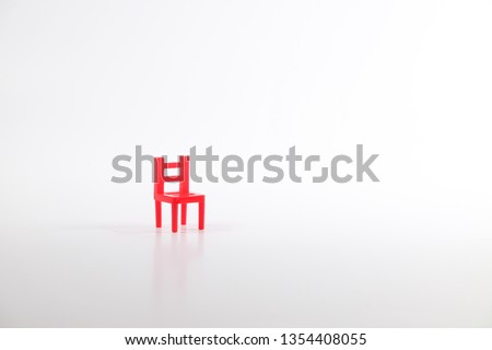 Red toy chair isolated on white background