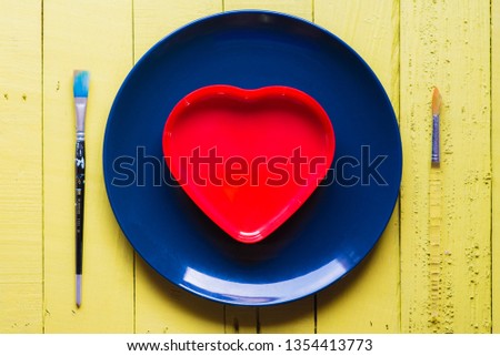  Dishes and brushes and hearts on a yellow wood floor from the top view