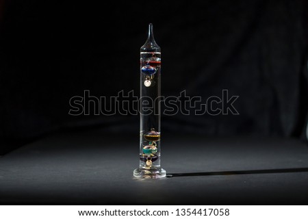 Galileo thermometer, dark dramatic picture on black background