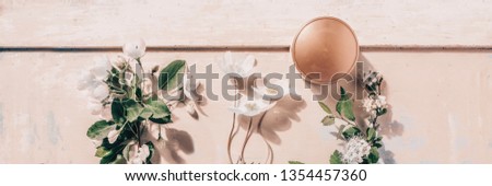 Natural organic cosmetics: serum, cream, mask on wooden background with flowers. Skincare concept