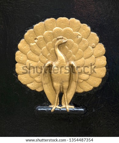 Gold peacock emblem