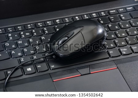 computer mouse on laptop keyboard