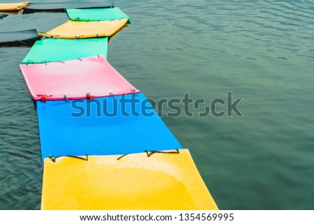 Fresh colored foam sheets placed on the river surface. Color foam floating on the surface of the river.