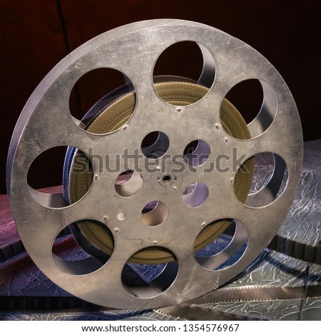 35 mm film reel with dramatic lighting on a dark background - image