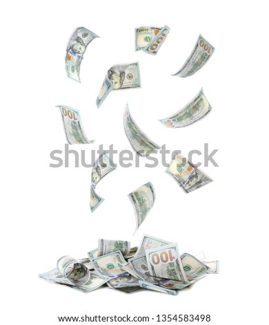 American banknotes falling into pile on white background