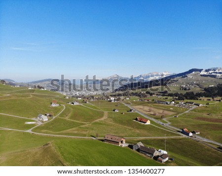 Drone view of canton Appenzell, Switzerland, green meadows and blue sky