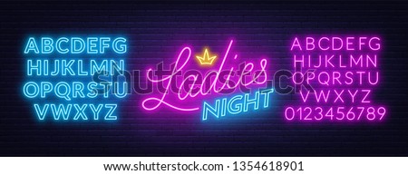 Ladies Night neon lettering on brick wall background. Royalty-Free Stock Photo #1354618901