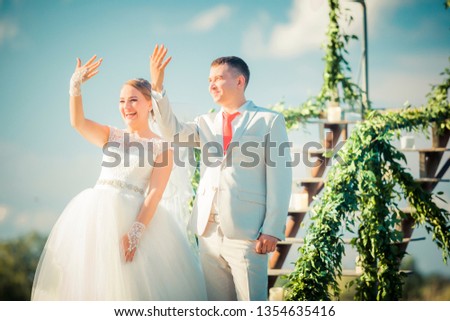 Young happy bride and groom couple showing rings on a wedding party