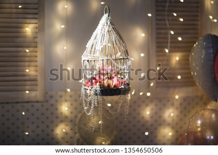background with cage with flowers lights, beads and dark style