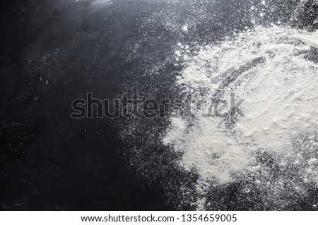 Flour on the table background Royalty-Free Stock Photo #1354659005
