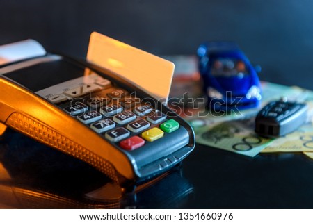 Credit card with terminal, toy car and australian dollar