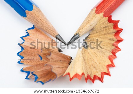 Blue and red pencils with leftovers on white background