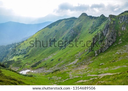 Majestic mountain range and rugged hills covered in green lush grass, Marmarosy ridge, Carpathian, Ukraine 