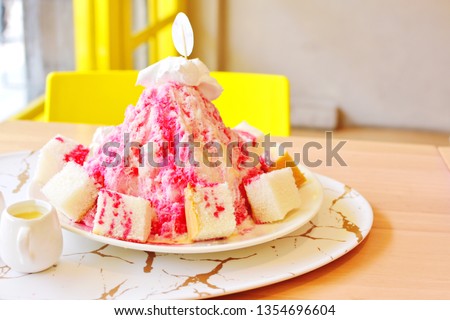 Iced shaved or Bingsu with red sweet syrup and small sliced bread in white plate, traditional Korean cool dessert for refreshing summer, big size dish cold pastry in dessert cafe, colorful picture