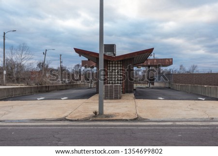 Abandoned outdoor bank teller in depressed urban area of St. Louis Missouri on cloudy overcast day