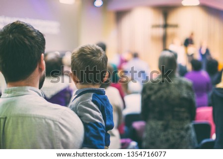 Father with his son participate at christian congregation worship Royalty-Free Stock Photo #1354716077