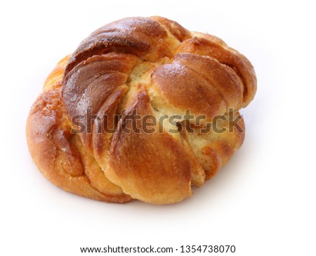 Freshly baked cinnamon bun. Cinnamon roll pastry on white background. Close up stock photo.