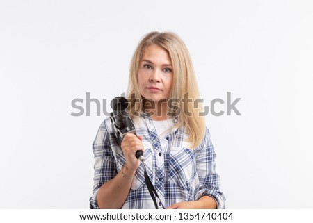 People, photographer and gesture concept - woman using an old fashioned camera on white background