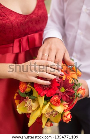 Wedding couple. hands and rings on bride's bouquet. declaration of love. Wedding background, day details